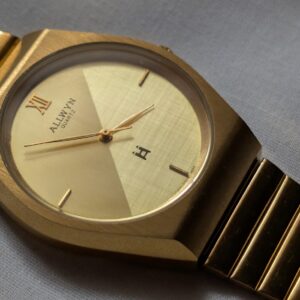 Allwyn Quartz Golden Dual tone dial, stylish yet elegant watch, soft lighting diagnoal shot showcasing the texture of the sophisticated dial design
