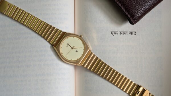 Allwyn Quartz Golden Brushed metal finish lying on a book