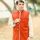 A man posing in traditional wear outdoors in a Lahore park.